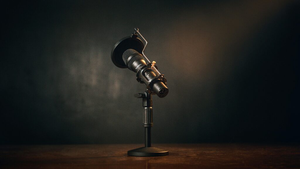 Close-up of a professional microphone setup in a dimly lit recording studio.